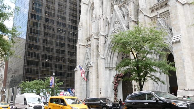 New York City, United States - 11 Sept 2023: Manhattan Midtown street, Fifth 5 avenue, 5th ave, American urban road car traffic, Yellow taxi cab in USA. Saint St Patricks Cathedral. People pedestrians
