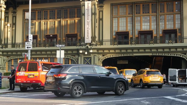New York City, United States - 4 Sept 2023: Manhattan Downtown Financial District, USA. Road car traffic. Yellow taxi, people. Battery Maritime Building ferry terminal, Whitehall Street. Firefighters.