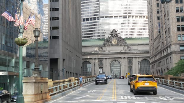 New York City, United States - 4 Sept 2023: Grand Central Terminal railway station building, 42 street. Manhattan Midtown. Yellow taxi cab, car transport on bridge, USA. American urban road traffic.