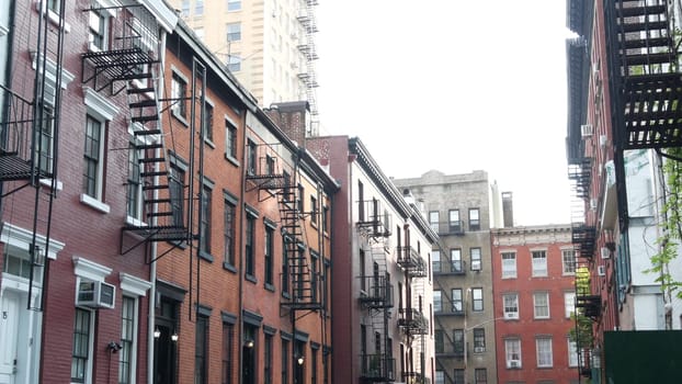 New York City, United States - 10 Sept 2023: Building architecture. Urban residential house exterior. Real estate property, USA. Red brick facade. Greenwich Village Gay street. Fire escape ladder exit