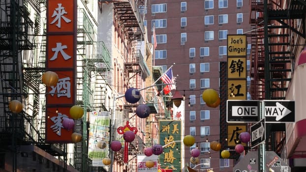 New York City, United States - 14 Sept 2023: Manhattan Chinatown Pell street. Chinese culture, ethnic district architecture, USA. Red brick buildings, paper lanterns and hieroglyph signs. Little China