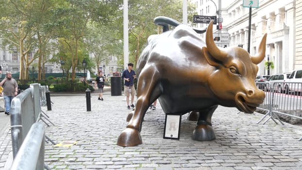 New York City, United States - 9 Sept 2023: Charging Bull, Wall street Stock Exchange symbol in USA. Lower Manhattan Downtown Financial District. American Broadway street. Tourist people photographing