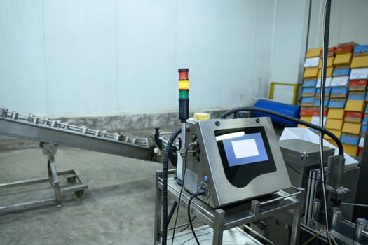 Industrial control panel with indicator lights in a food packaging facility.