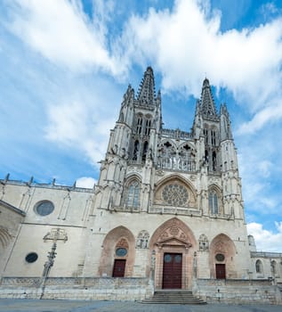 A breathtaking Gothic cathedral with detailed architecture against a bright blue sky, embodying historical artistry.