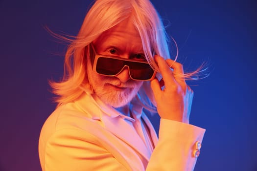 Dapper senior man with long white hair wearing sunglasses, set against a colorful blue and orange backdrop, embodying a stylish and confident character, ideal for modern fashion concepts