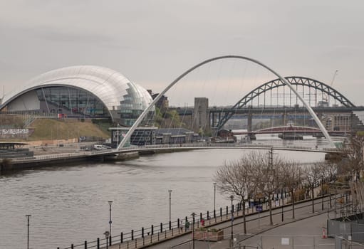 Newcastle, UK - Apr 12, 2025 - Stunning view of The Iconic gateshead millennium bridge spanning the River Tyne with Sage Gateshead and Tyne bridge in the background. use it as your Wallpaper, Poster and Space for text, Selective focus.