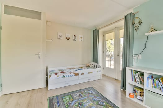 A serene children's room featuring light colors, a bed with decorative bedding, large windows, and a cozy atmosphere conducive for play and relaxation.