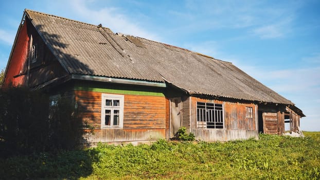 Weathered wooden farmhouse revealing structural decay, symbolizing rural abandonment and economic hardship
