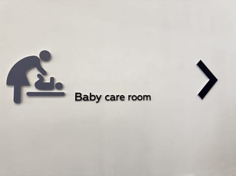 Inclusive baby care room sign in public space. Symbol of support for parents and caregivers. Promotes accessibility, equal opportunity, and family-friendly urban infrastructure