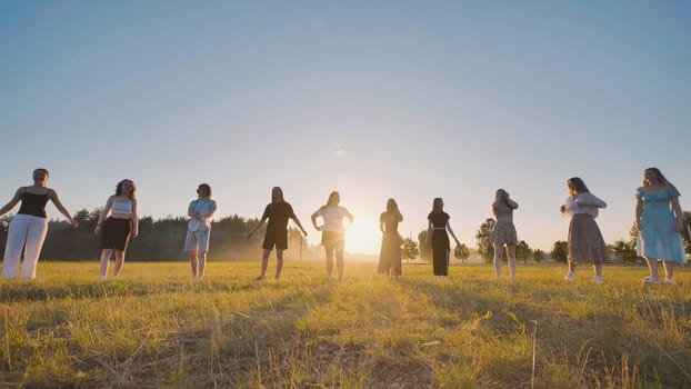 Group of high school students celebrating summer at sunset, gathering in a vibrant field, enjoying friendship and carefree moments together