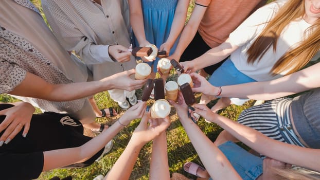School friends having a delightful time with ice cream cones and chocolate bars on a sunny day