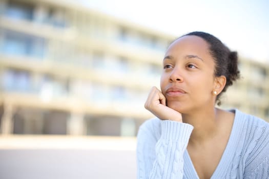 Black woman thinking looking away in the street