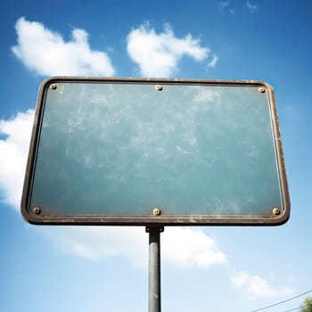 Blank road sign with blue sky and white clouds background