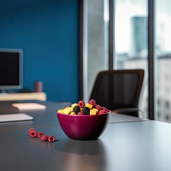 A bowl of fresh fruit salad on a desk in a modern office