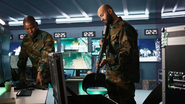 Army soldiers packing weapons able to engage targets at extended range with accurate, lethal fire. Military units loading guns with bullets, preparing for enemy suppression mission, camera B