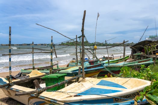 Galle Sri Lanka - September 14 2024; Village fishermen small boats with makeshift rigging of sticks and rope.