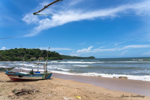 Galle Sri Lanka - September 14 2024; Traditional picturesque style fisherman’s boats pulled up on sand at beach near city and one with New Zealand fern emblem.