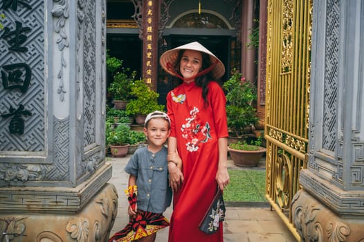 happy woman mother with son tourists travelers at a Buddhist temple in Vietnam in Asia