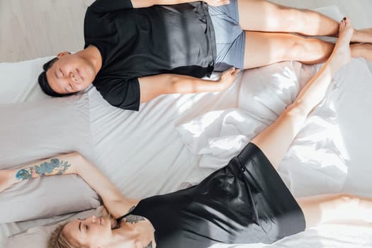 A man and a woman woke up the morning in the bedroom on the bed