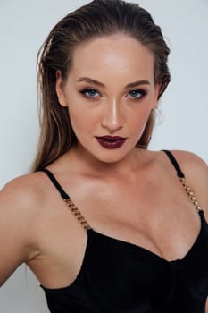 Fashionable woman in black clothes and makeup on white background