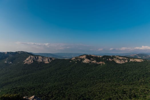 Beautiful landscape on the mountains and green forest with blue sky from the top of the cliff
