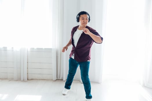 Man in headphones listening to music and dancing