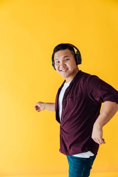 Man in headphones listening to music and dancing