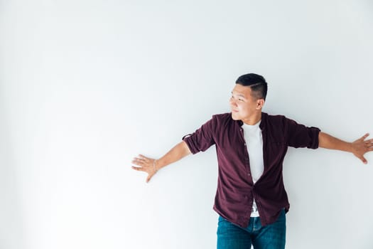 Asian man dancing to music alone in room