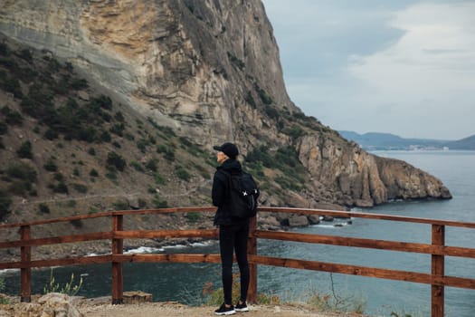 Female tourist looking at seascape from mountain top