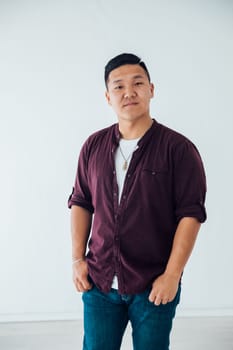 Portrait of Asian man in shirt and jeans on white background