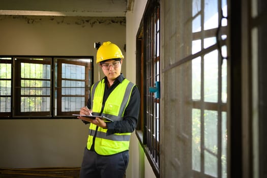 Site supervisor using digital tablet to inspect and manage residential construction.