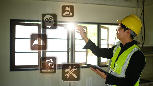 Futuristic smart construction concept with male engineer operating holographic controls.