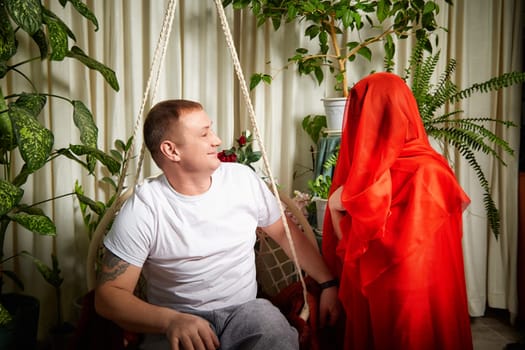 Couple enjoys a light-hearted moment while dressed in oriental attire,adding joy and humor to their role-playing game.