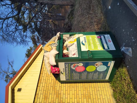 Overflowing Clothing Bin After EU Textile Collection Mandate, Impact of New Sustainability Rules