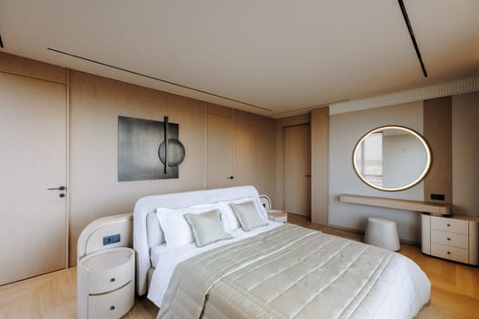 Unwind and relax in this chic and minimalist bedroom, showcasing stylish decor and soothing, calming colors