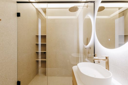This is a sleek and modern bathroom that includes a stylish sink and an inviting walkin shower, perfect for daily use and relaxation