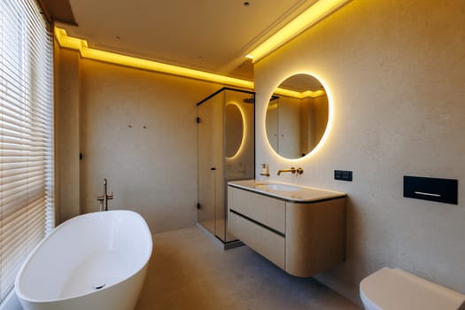 This is a welldesigned bathroom that includes a bathtub, a sink, a toilet, and a mirror, all essential for any bathroom space