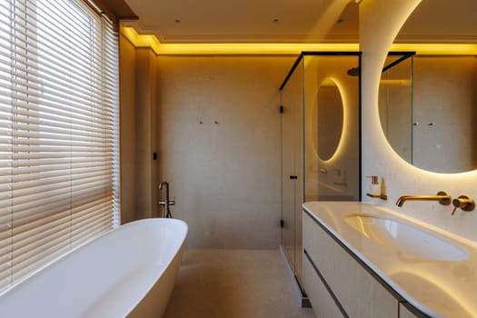 A welldesigned bathroom that includes essential features such as a comfortable bathtub, a functional sink, a stylish mirror, and a convenient shower area