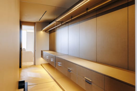 An expansive walkin closet featuring an abundance of drawers and shelves for optimal organization and storage of clothing and accessories