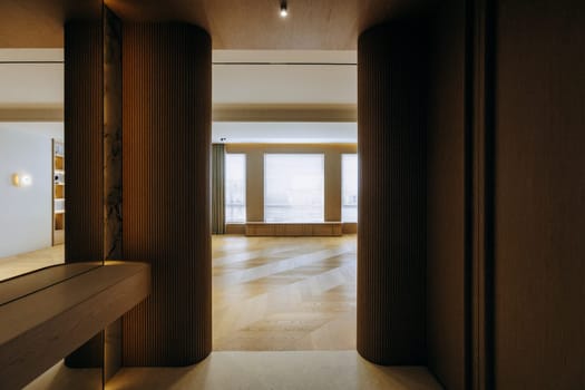 This modern interior style features wooden elements, ample natural light, and an elegant transitional space