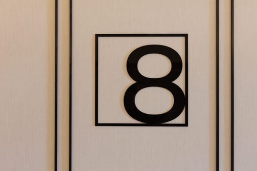 A striking black and white sign displaying the number eight prominently on it, serving as an essential part of house numbering