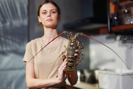 Young woman preparing lobster dish in kitchen with sink in background