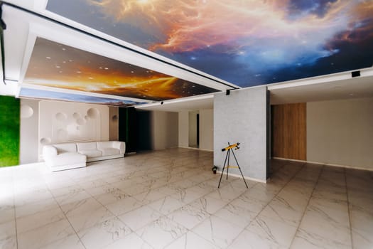 The cozy living room features a comfortable couch positioned alongside a telescope that is set on the floor for easy use