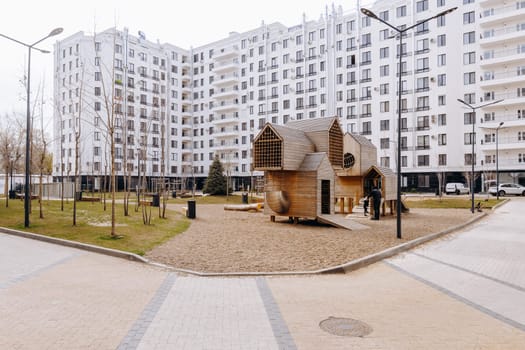 In front of a large, impressive white building, there is a playground, adding a touch of liveliness to the urban landscape surrounding it