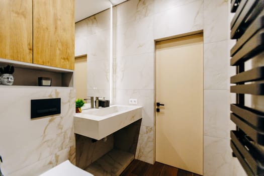 A bathroom that features essential amenities including a toilet, a sink, and a mirror for convenience and practical usage