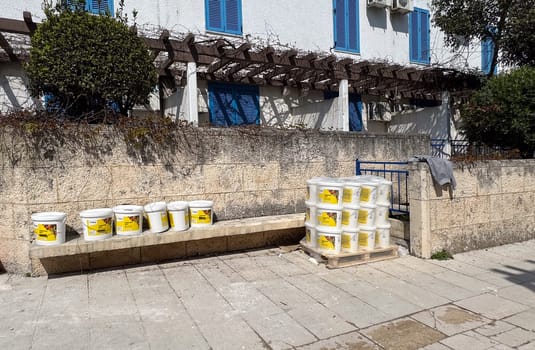 Budva, Montenegro - April 17, 2025: buckets of paint on one of the city streets. renovation and development of the city, repair of hotels. Updating and preparing for the tourist season
