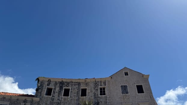 Budva, Montenegro - April 18, 2025: An abandoned structure under clear blue skies highlights themes of resilience and the importance of preserving history