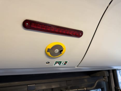 Interior detail of city bus showing an emergency door release system, part of the urban transport infrastructure designed for safety and accessibility