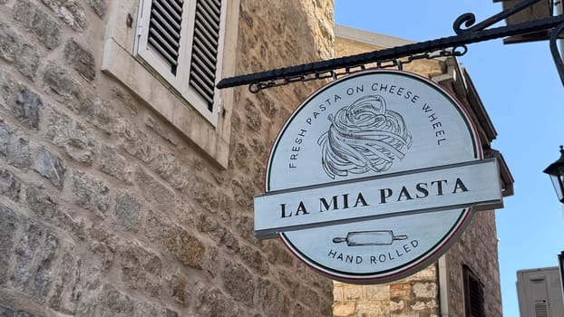 Budva, Montenegro - April 18, 2025: La Mia Pasta restaurant sign. Fresh pasta cooked in a cheese wheel, known as pasta alla ruota, is the most popular in the city.