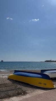 Budva, Montenegro - April 18, 2025: Colorful boats relax on the shores of the calm sea under clear skies, embodying sea relaxation and tranquility
